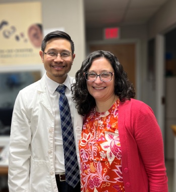 Alex HIS, Taking Photo with patient wearing a red sweater while smiling